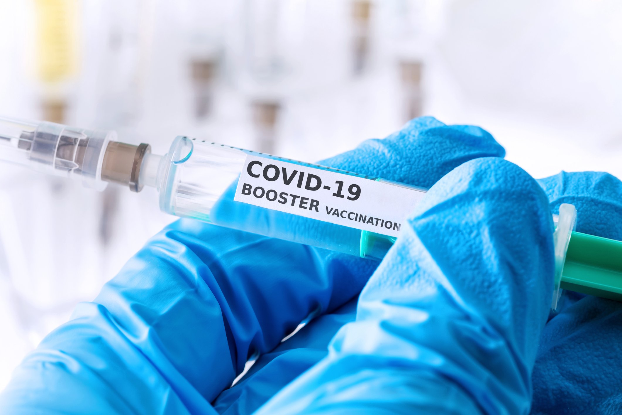 Syringe with a label that says COVID-19 booster vaccination.