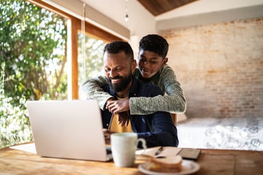 Father and son check stocks on computer