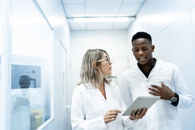 two scientists discuss data in laboratory