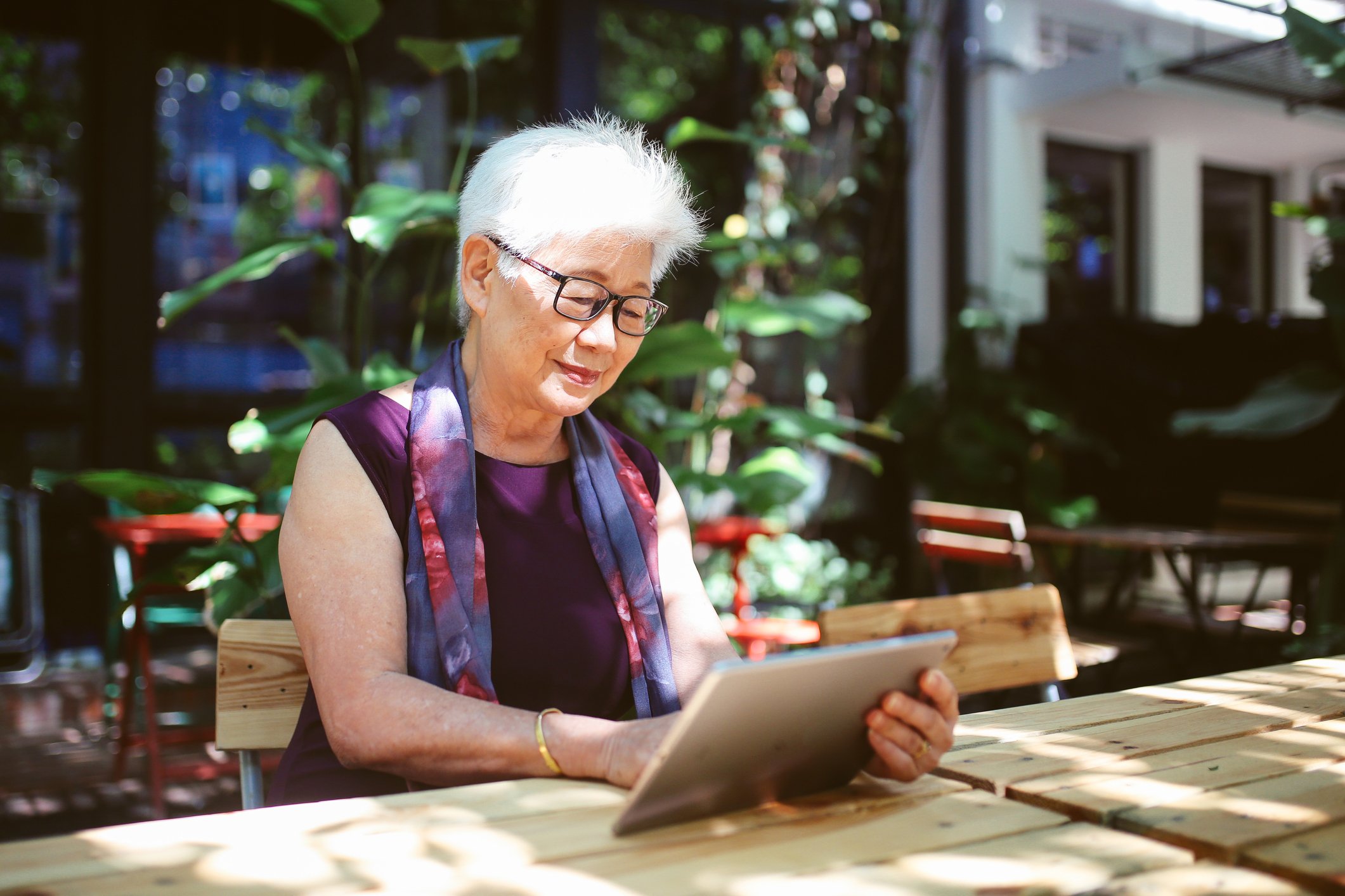 A woman using a tablet.