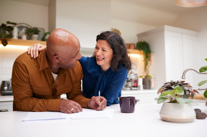 Two people in a kitchen having a conversation.