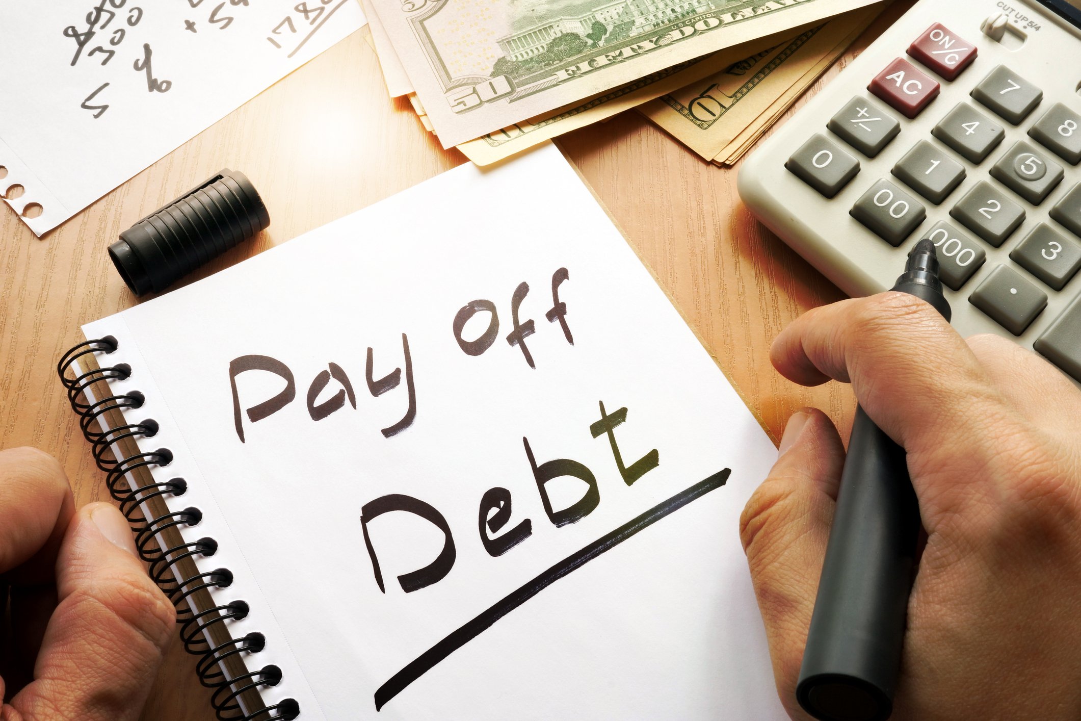 Pay off debt scrawled on a notepad
