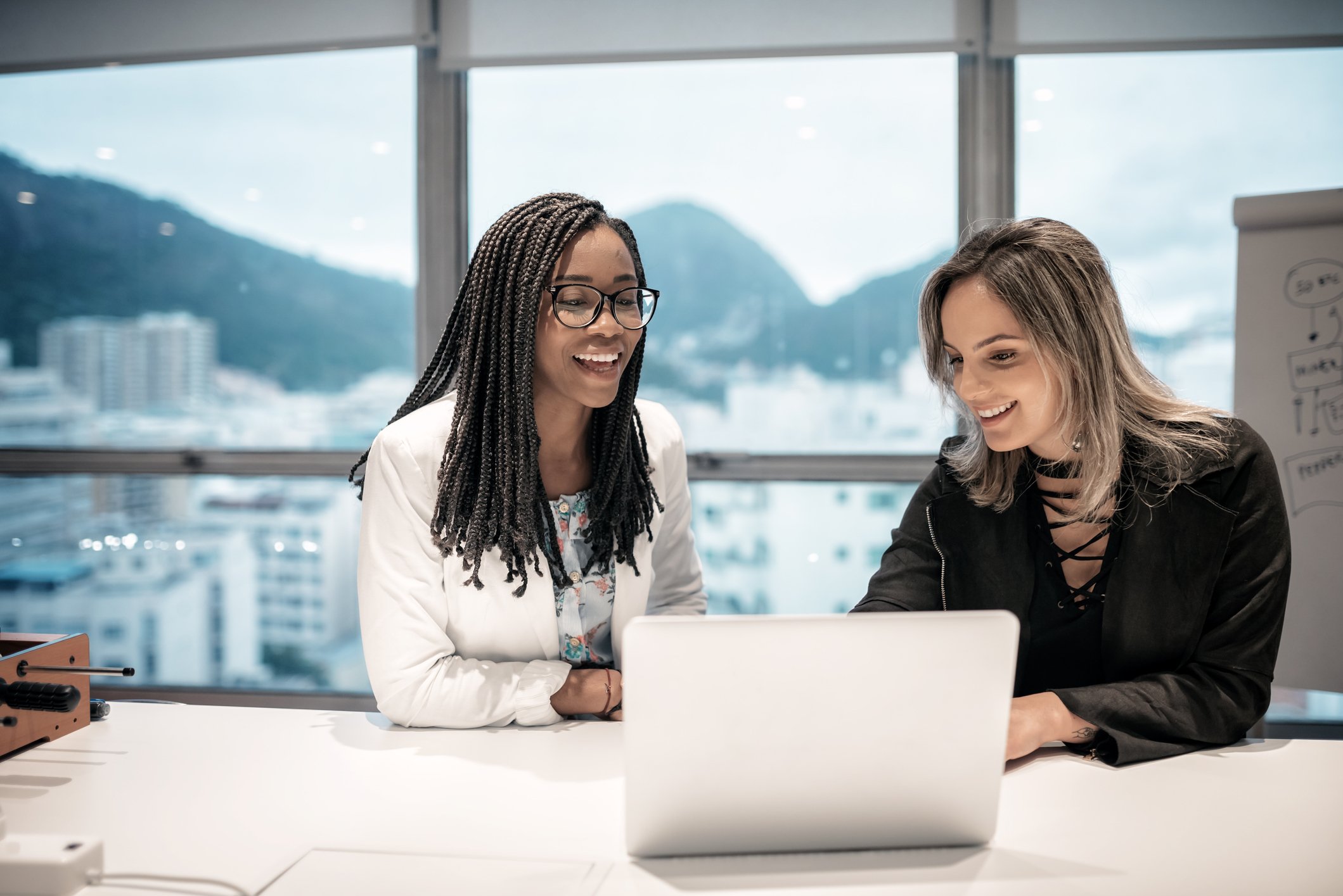 Two businesspeople looking at a computer in an office in Rio de Janeiro.