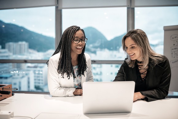 Two businesspeople looking at a computer in an office in Rio de Janeiro.