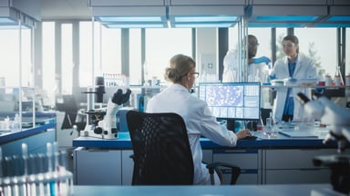 three people working in a laboratory