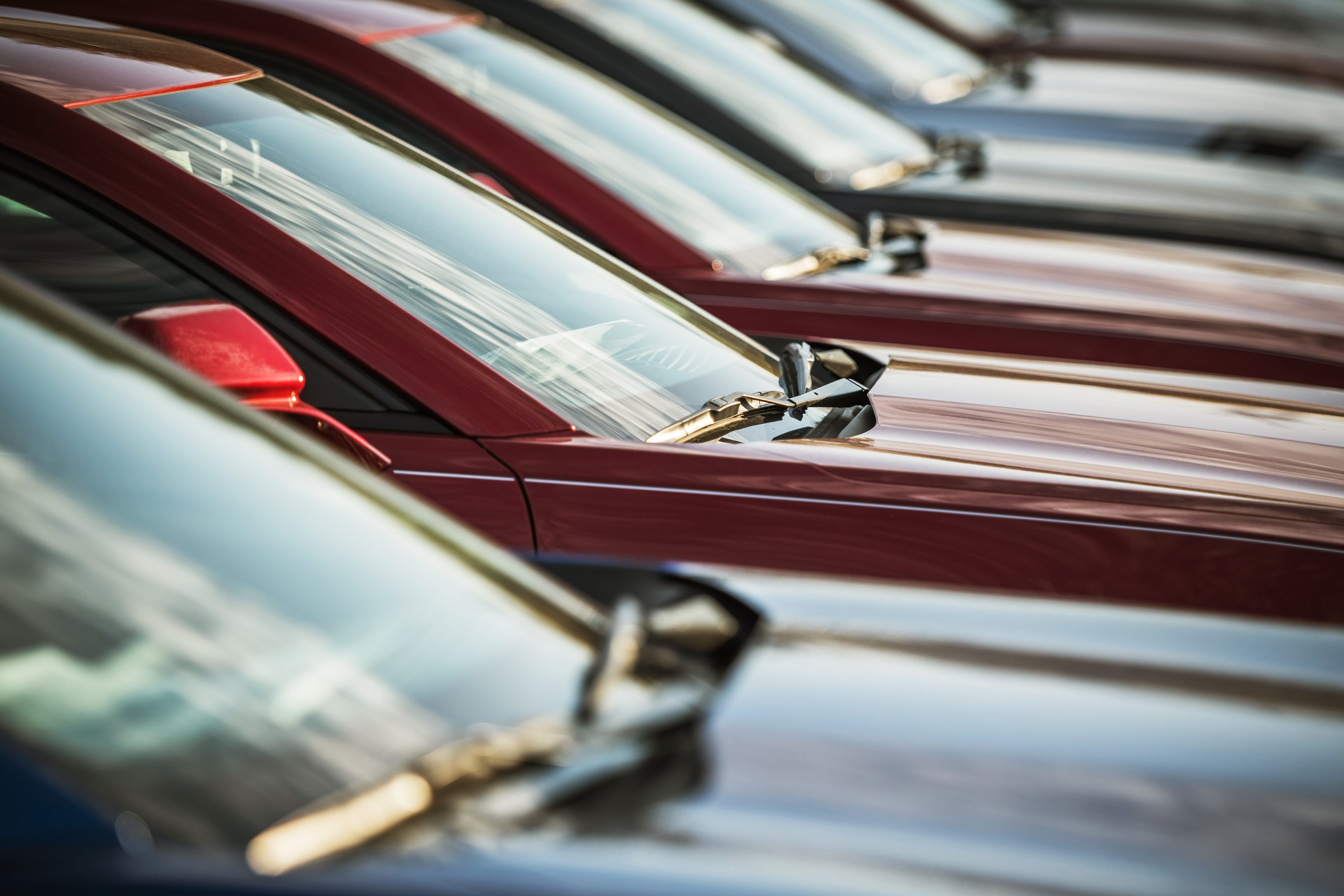 Windshields of cars in a row.