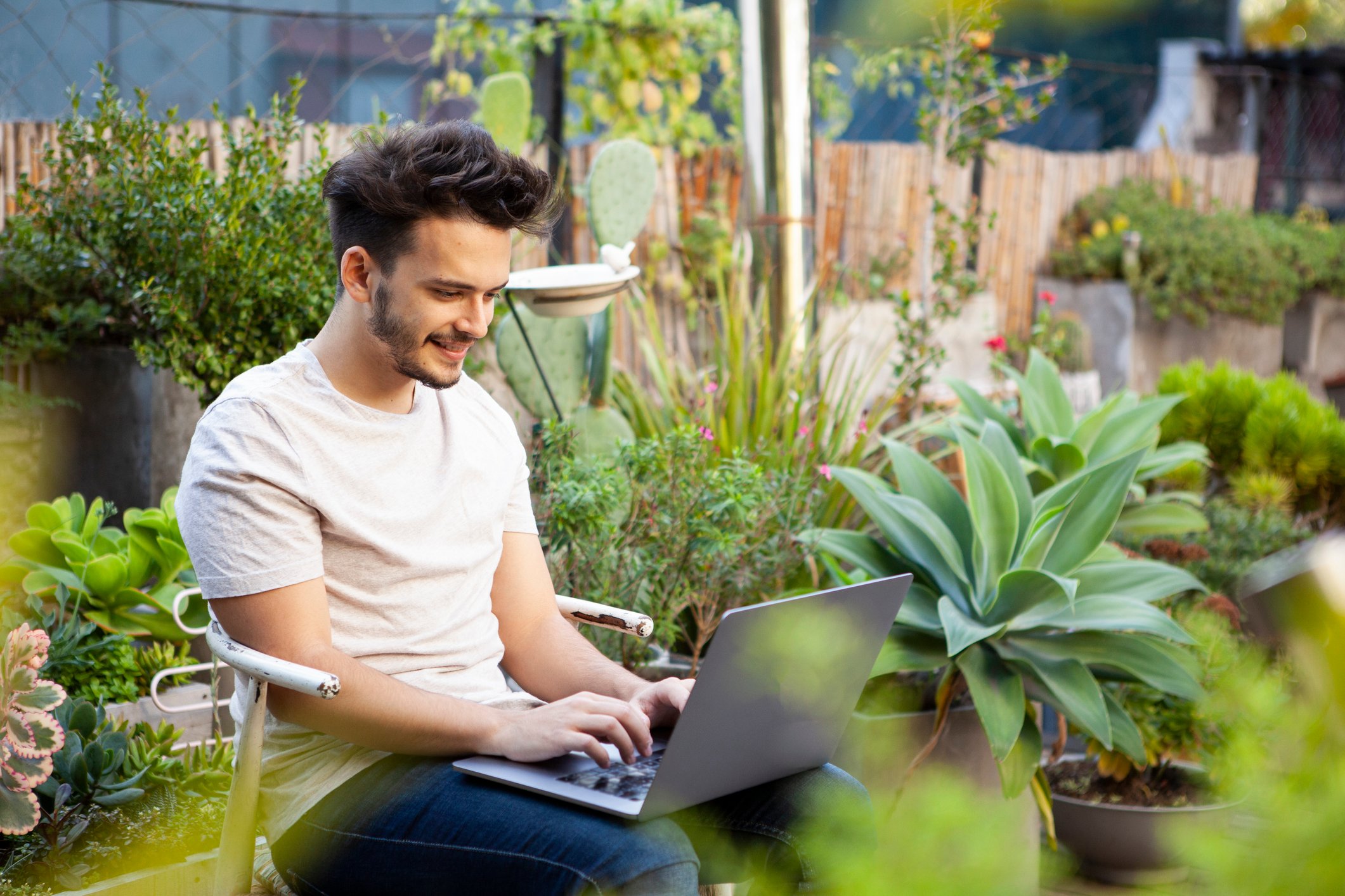 An investor browses his crypto portfolio outside in a rooftop garden.
