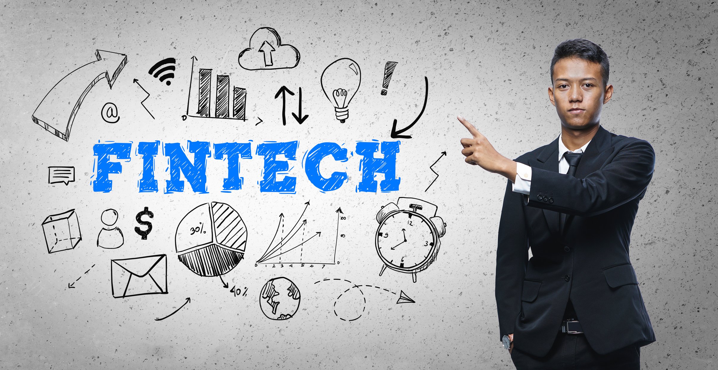 Person pointing at an image of the words Fintech.