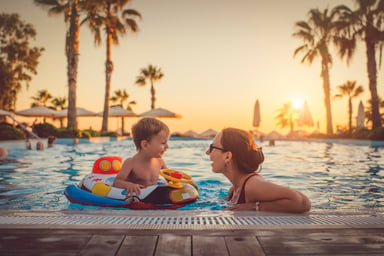 Adult and child frolicking in a pool
