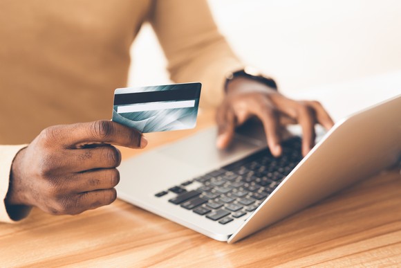 A person holding a credit card.