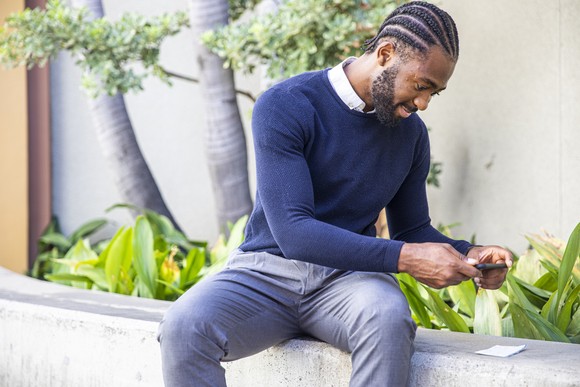 A person taking a picture of a check using a smartphone.