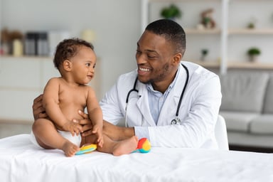Physician smiles at baby