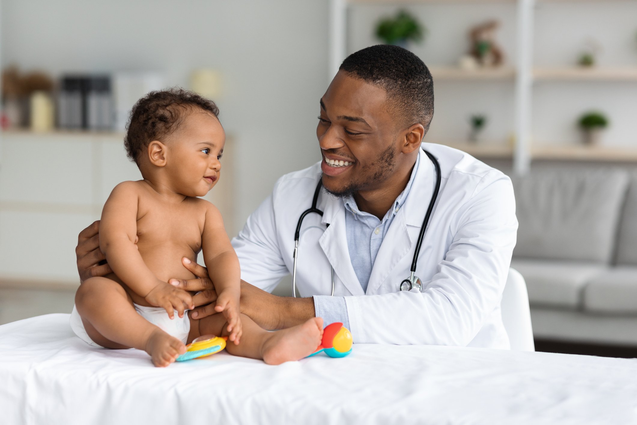 Physician smiles at baby
