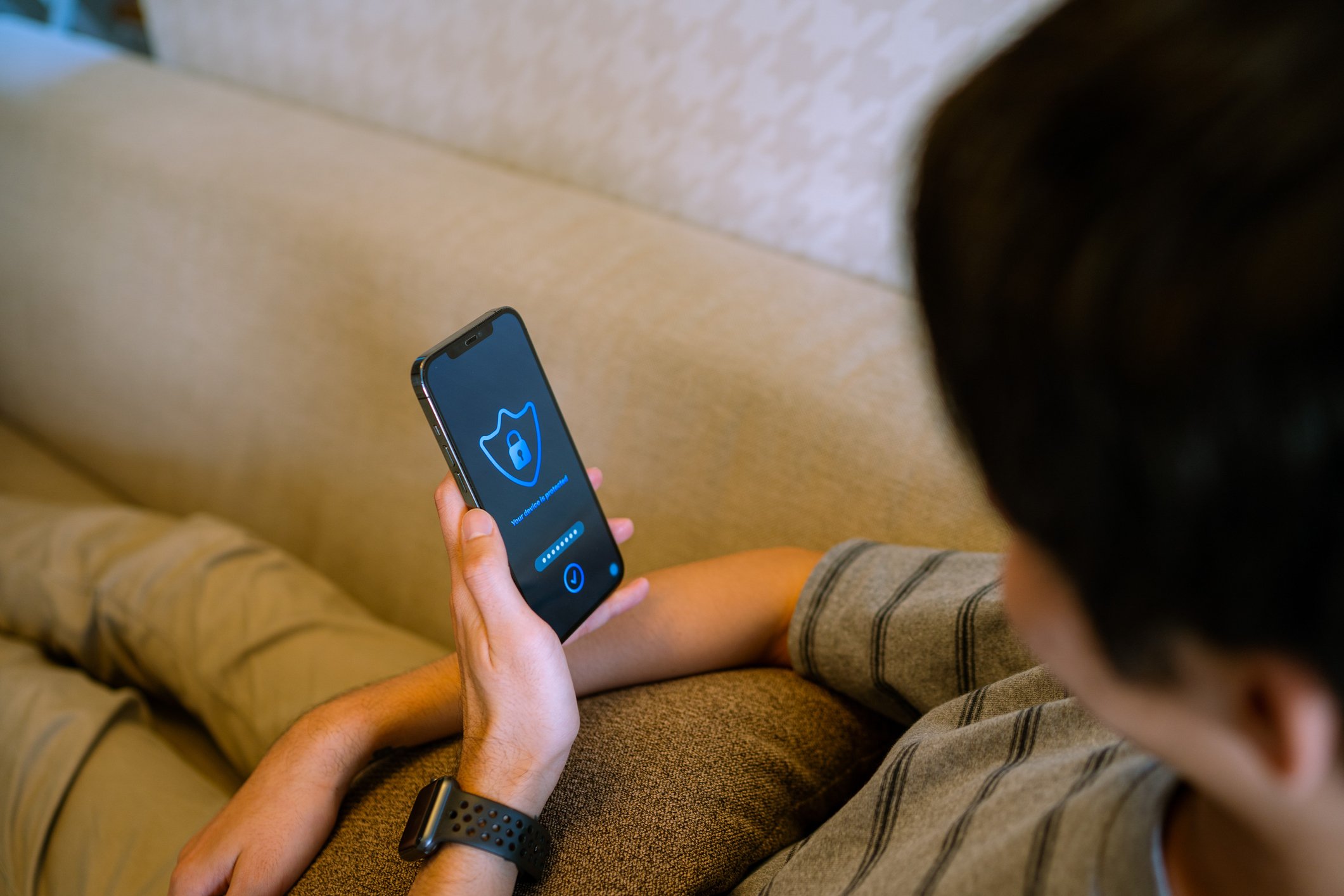 Person is looking at a security app on a mobile phone.