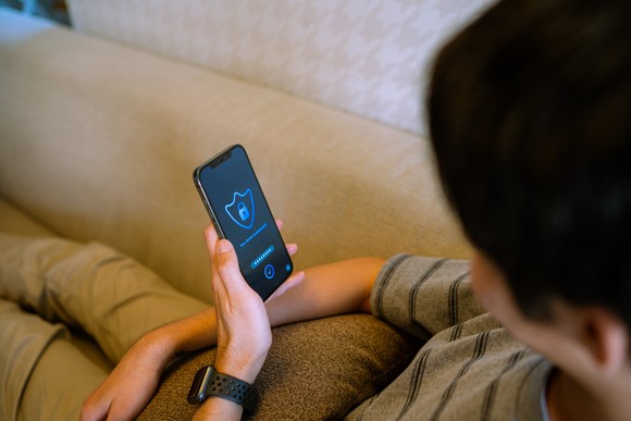 Person is looking at a security app on a mobile phone.