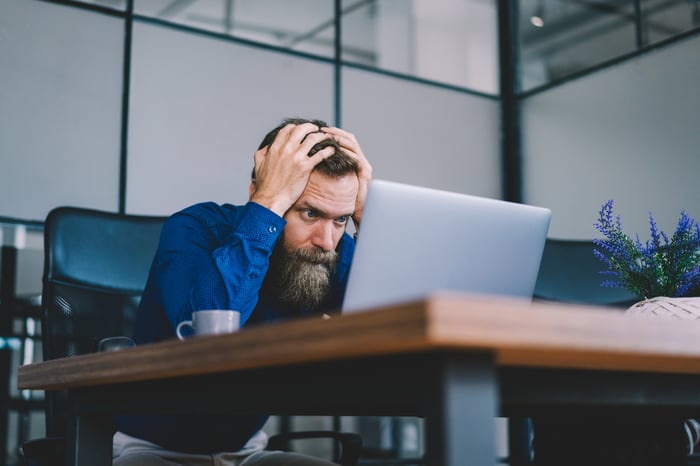 Person looking at computer in disbelief.