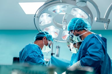 A team of surgeons works in the operating room