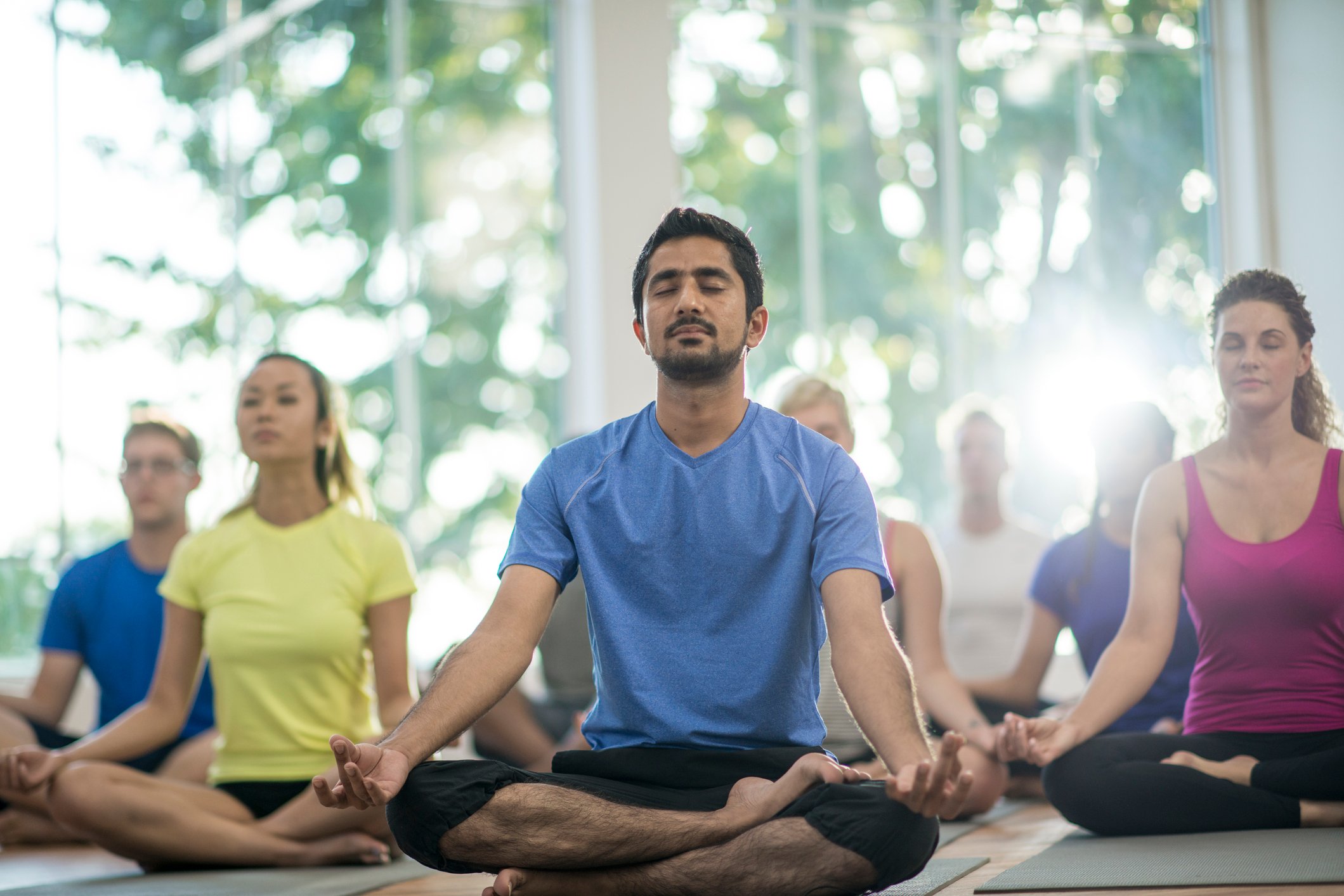 People sitting in a yoga class.
