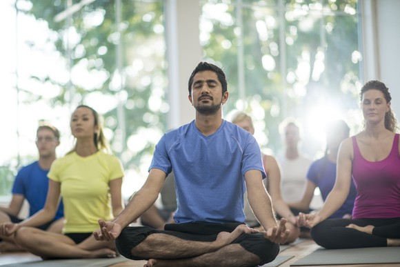 People sitting in a yoga class.