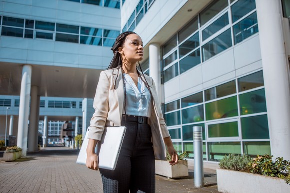 An employee walking outside a hospital.
