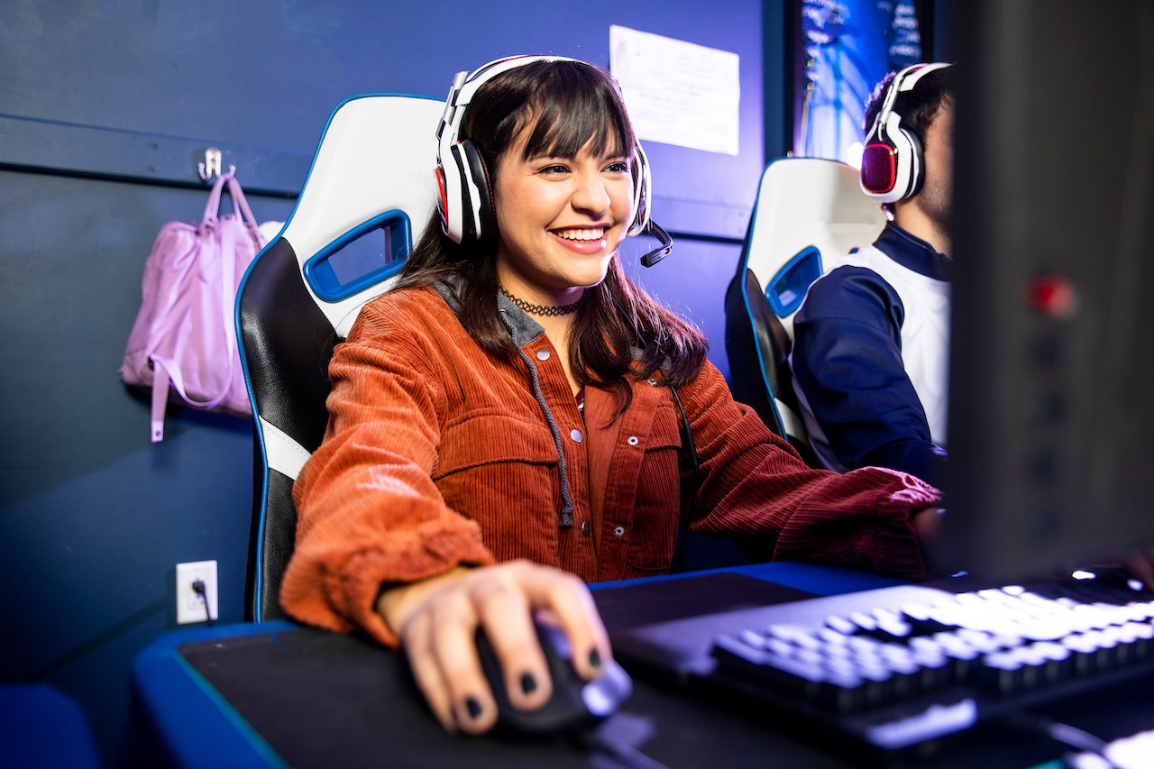 Computer gamers in headsets chatting while playing.