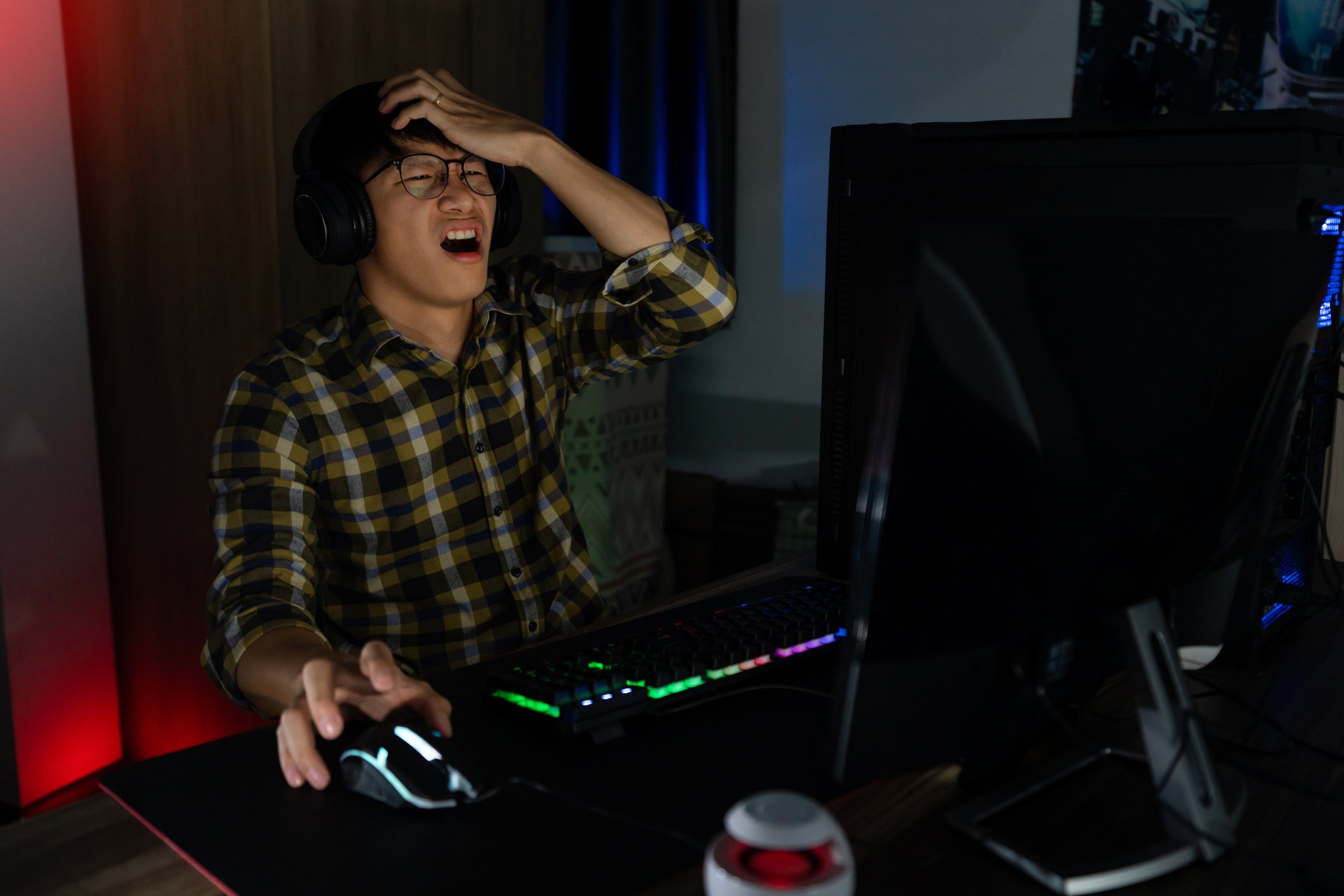 A PC gamer gets angry while playing a game.