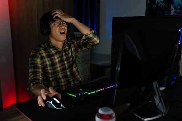 A PC gamer gets angry while playing a game.
