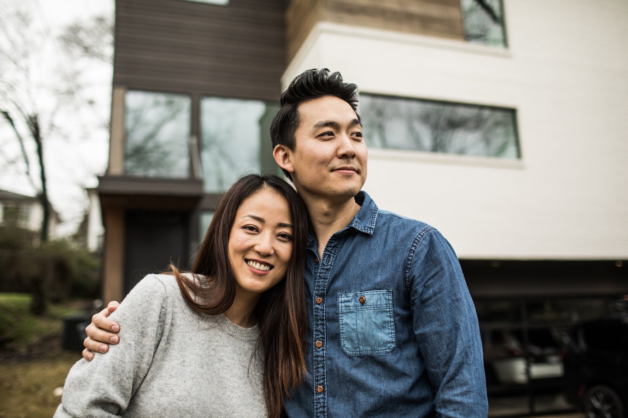 Couple standing in front of house.