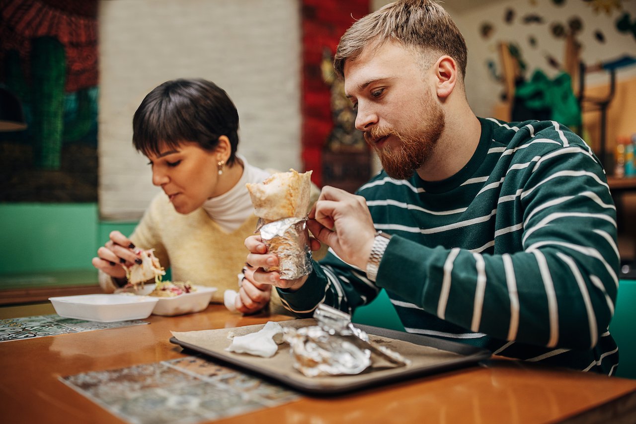 couple eating take out dinner food drinks