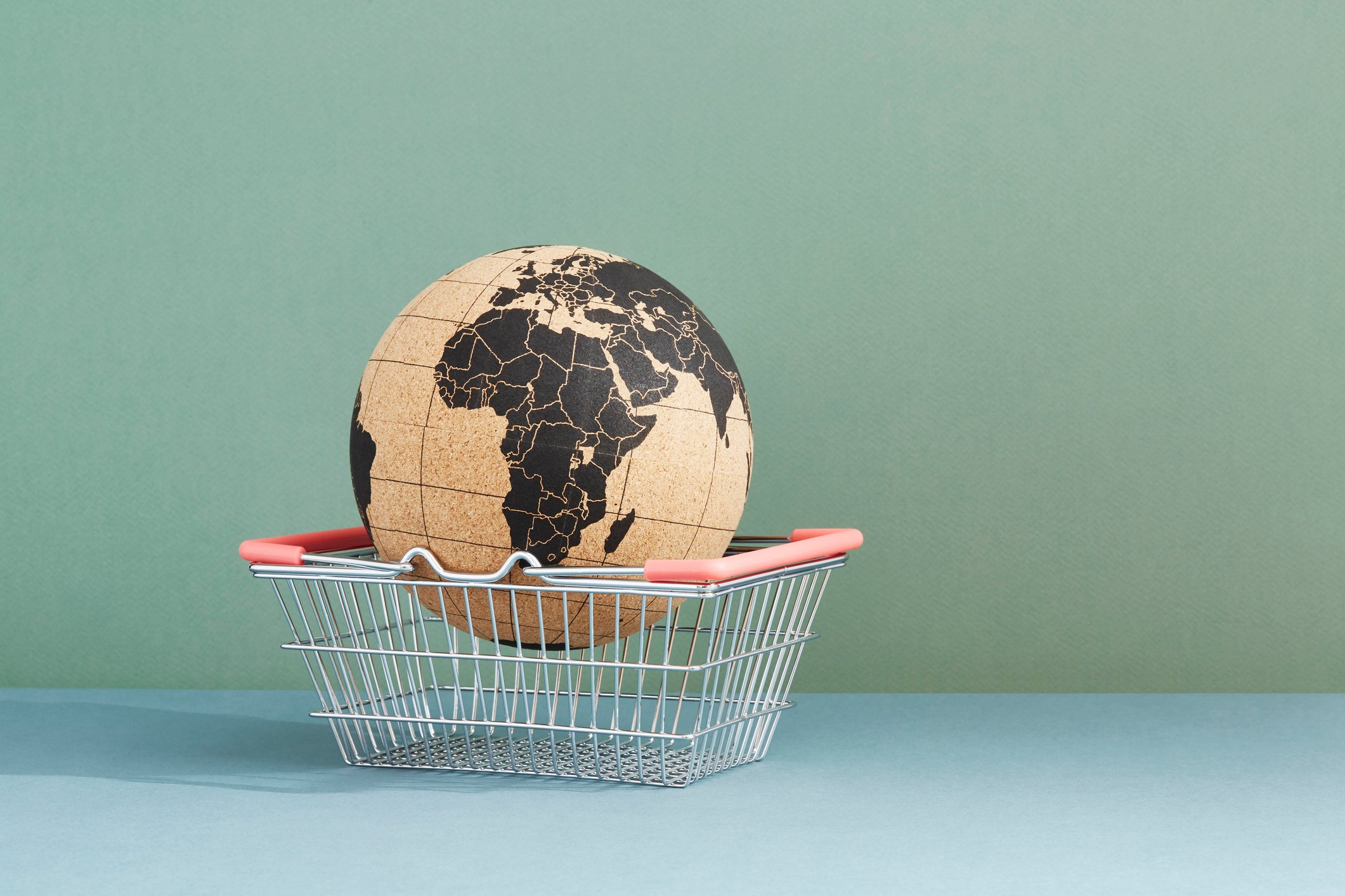 Model of the globe in a metal shopping basket.