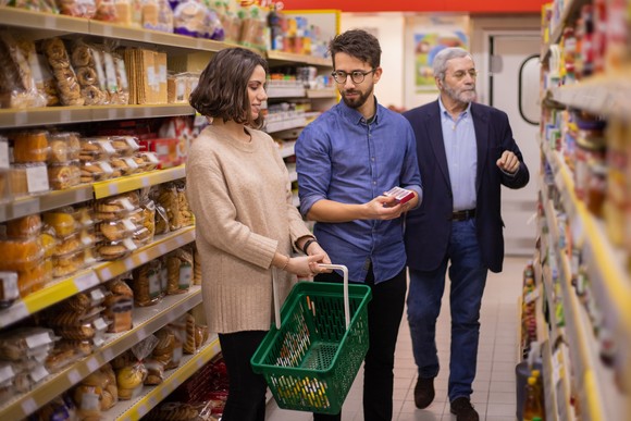 People standing in a store aisle.