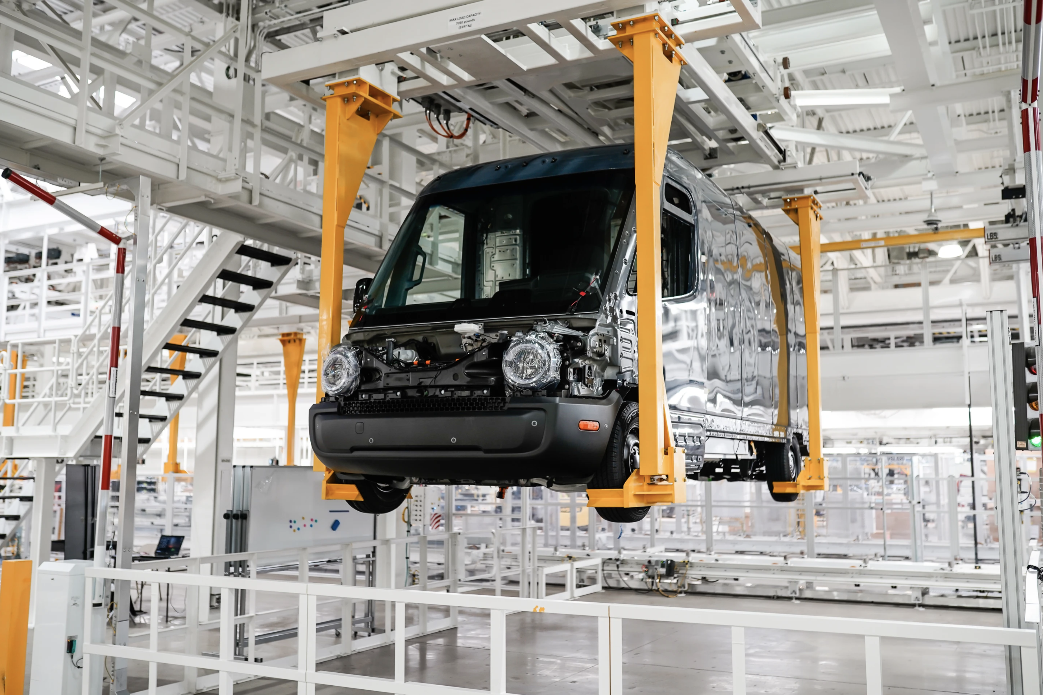 A Rivian delivery van is being made in a manufacturing facility. 