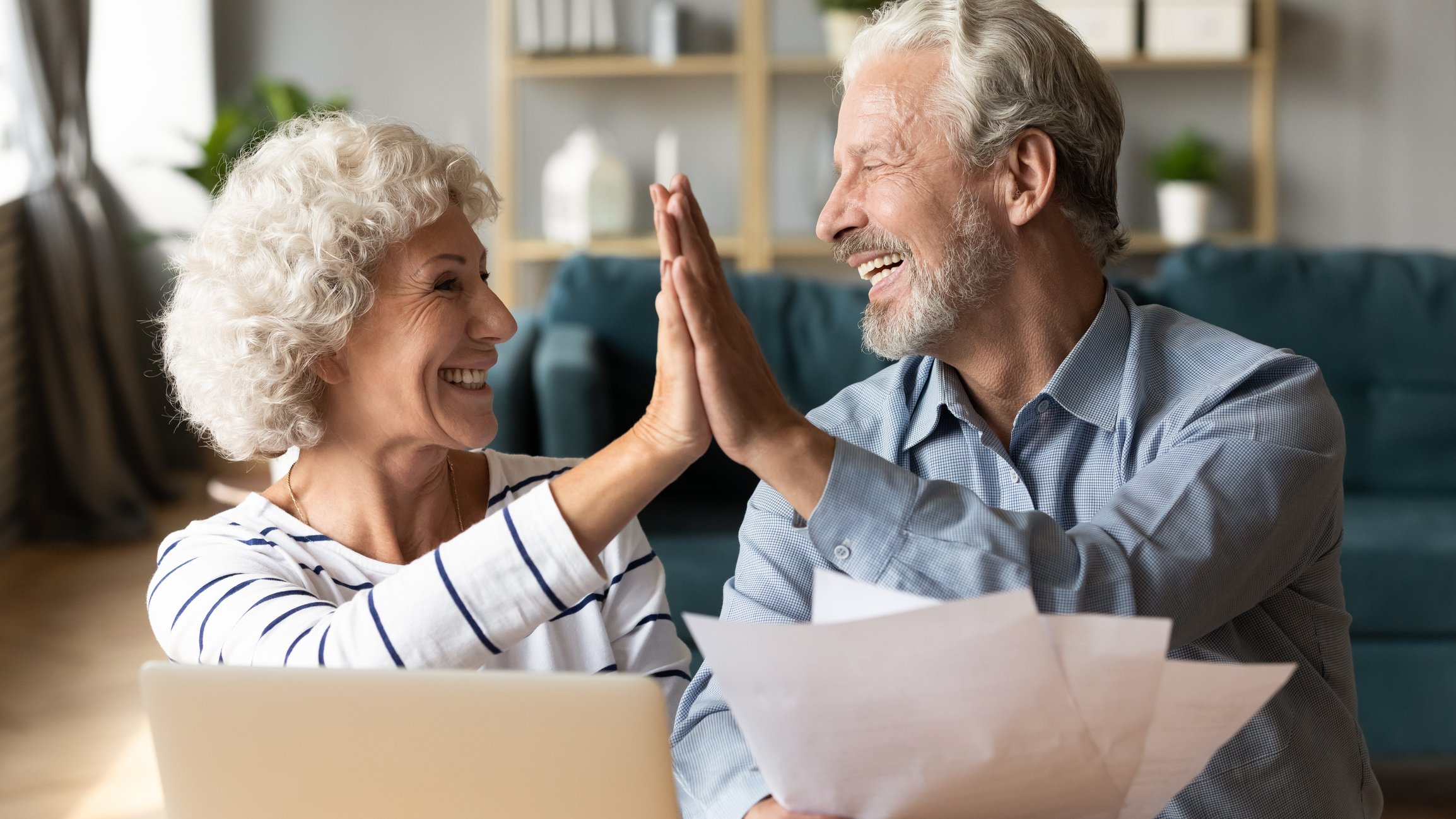 Mature couple giving each other the high-five.