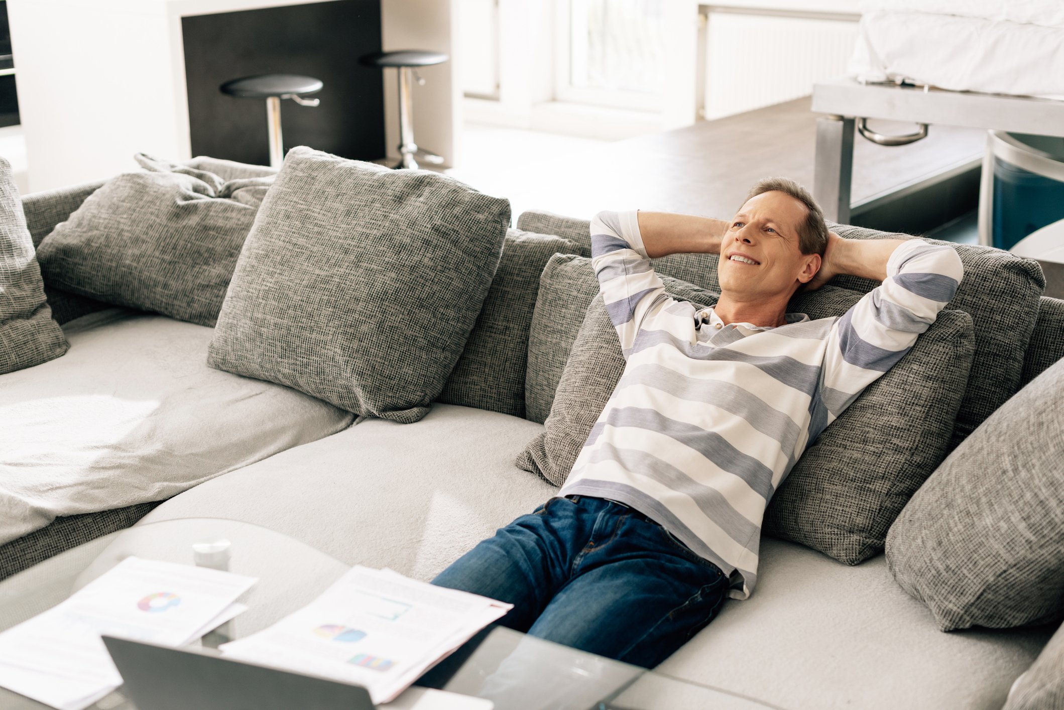 A smiling person sitting on a couch.