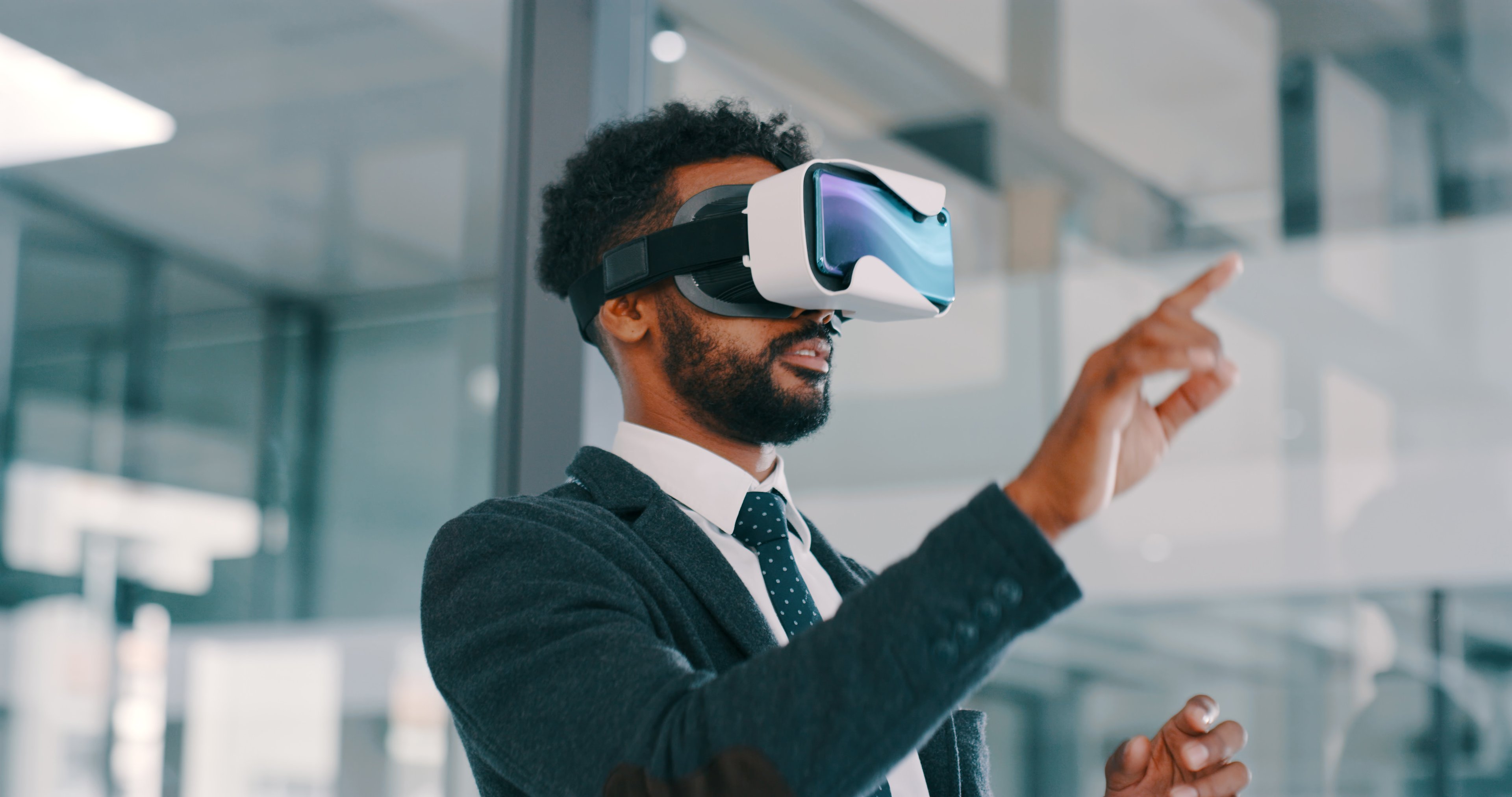 Person in a suit using a VR headset.