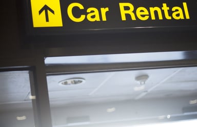 Car Rental sign pointing up