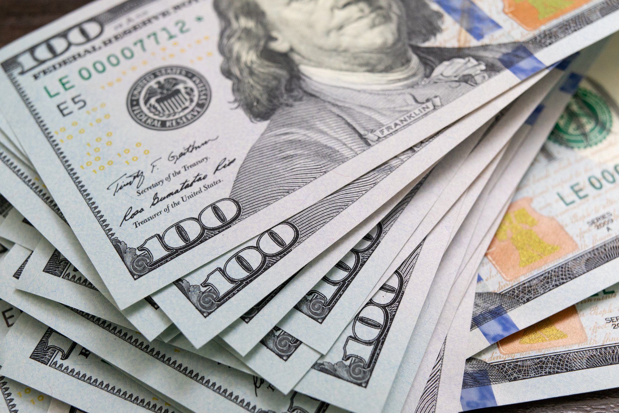 $100 U.S. banknotes stacked over one another