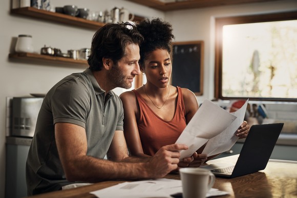 Couple looking at paperwork together.