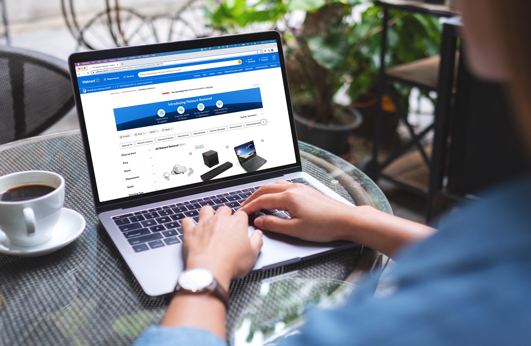 Person on laptop browsing Walmart Restored website.