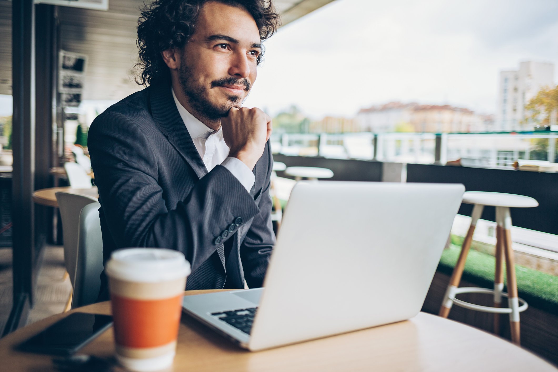 An investor researches stocks at a coffeehouse.