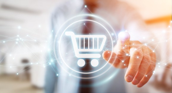 A person touching a shopping cart icon.