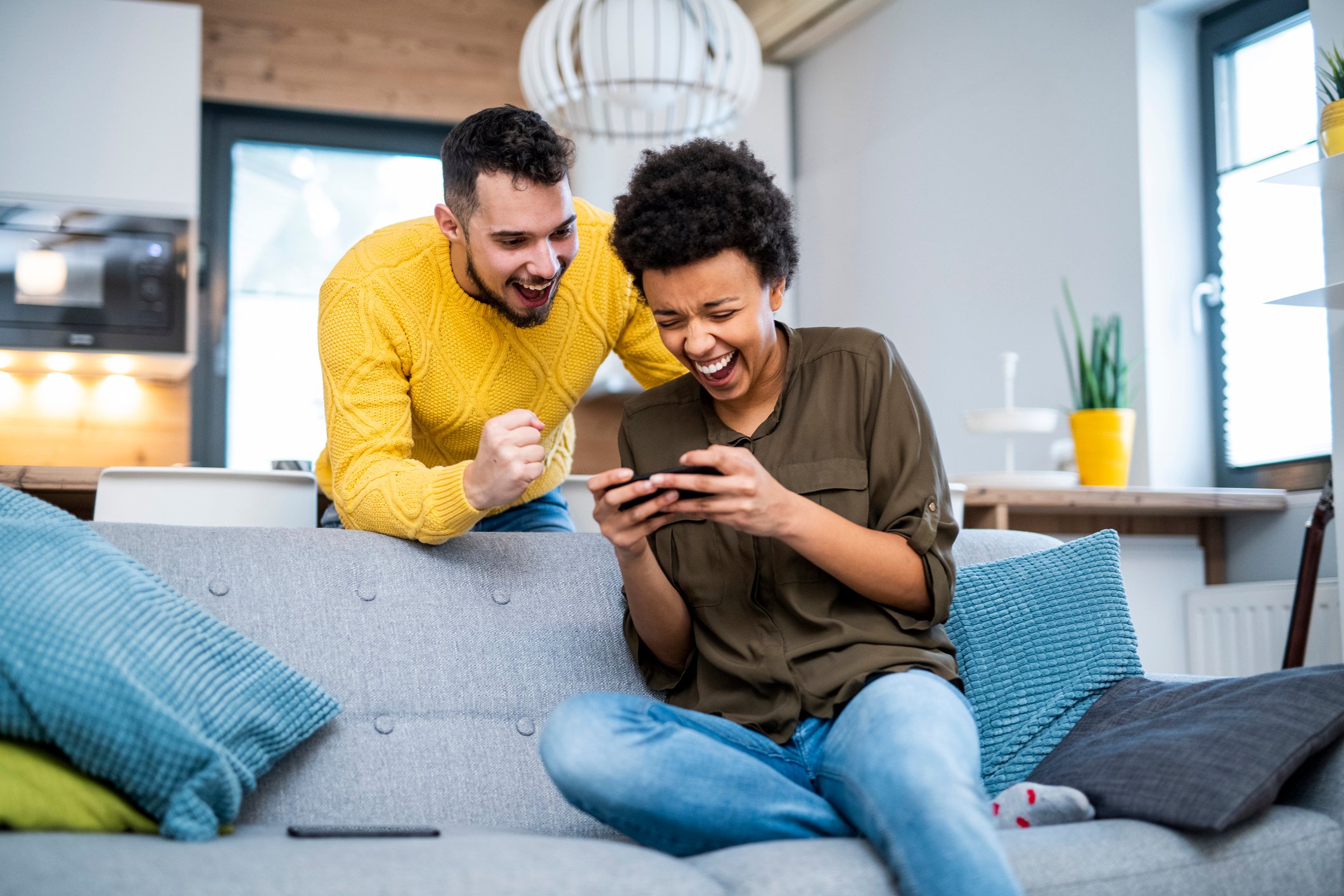 Two people playing a mobile video game.