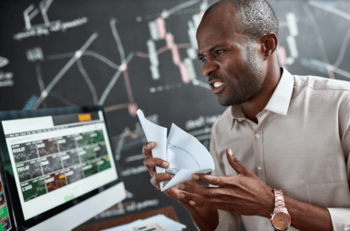 frustrated trader stock charts loses money