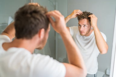Man applying hair care product
