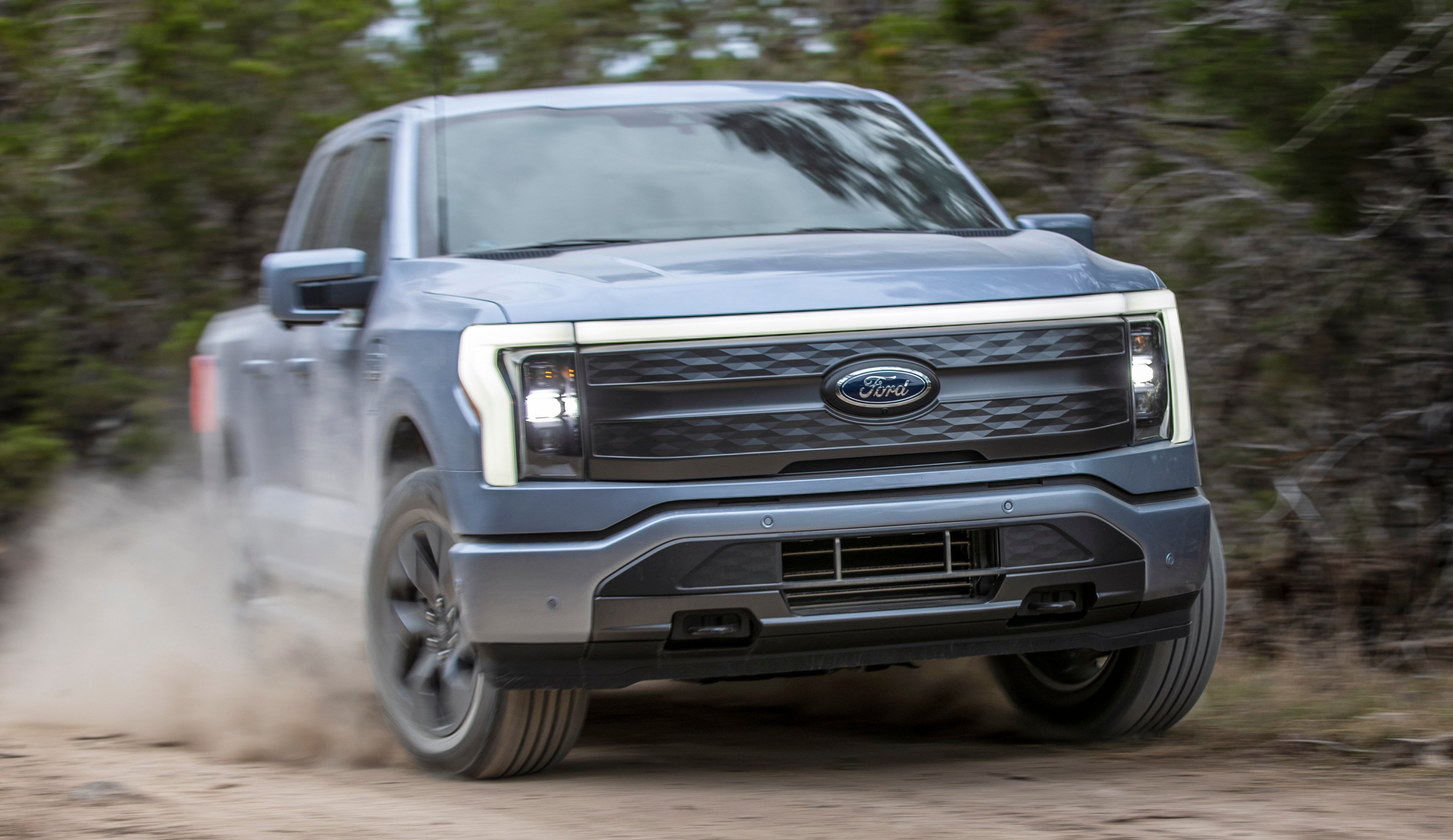 A Ford F-150 Lightning Lariat driving off-road. 