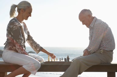 seniors playing chess on beach