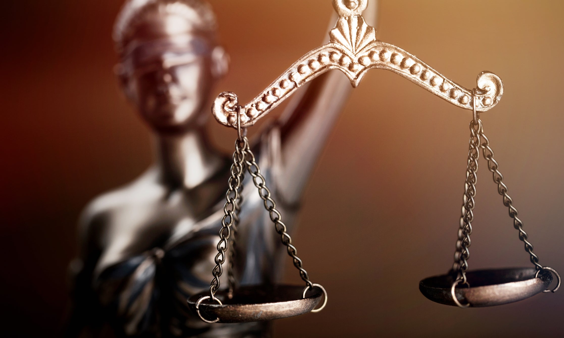 Statue of Justice holding balanced scales.