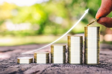 A person putting another coin on a growing stack.