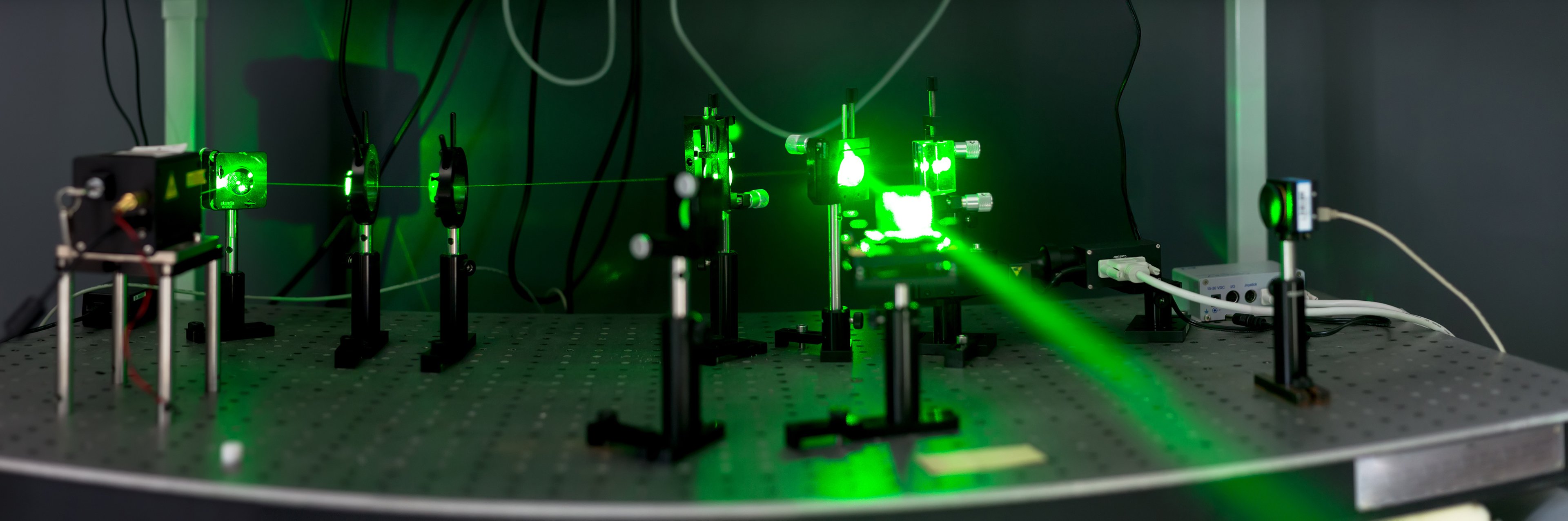 Green laser beam fired in a lab.