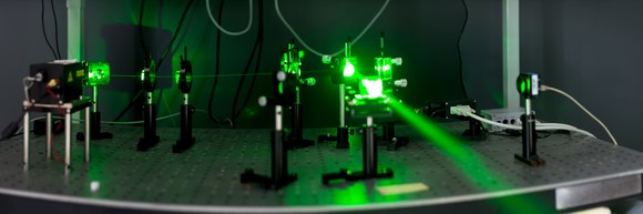 Green laser beam fired in a lab.